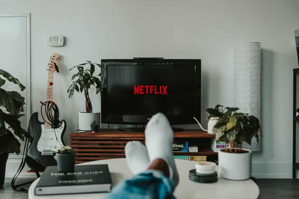 Feet up on a coffee table while watching Netflix