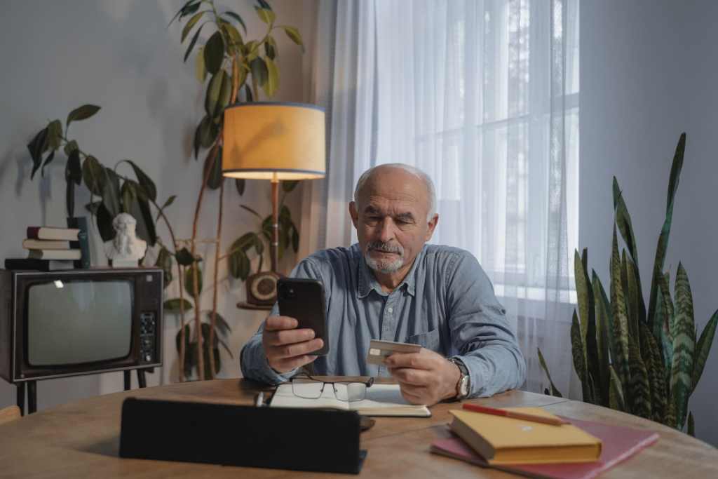online spending man on laptop with credit card