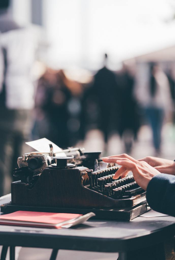 someone typing on a typewriter without distractions