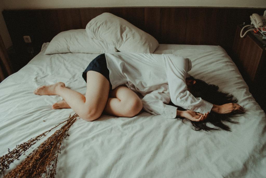 girl laying on bed without energy